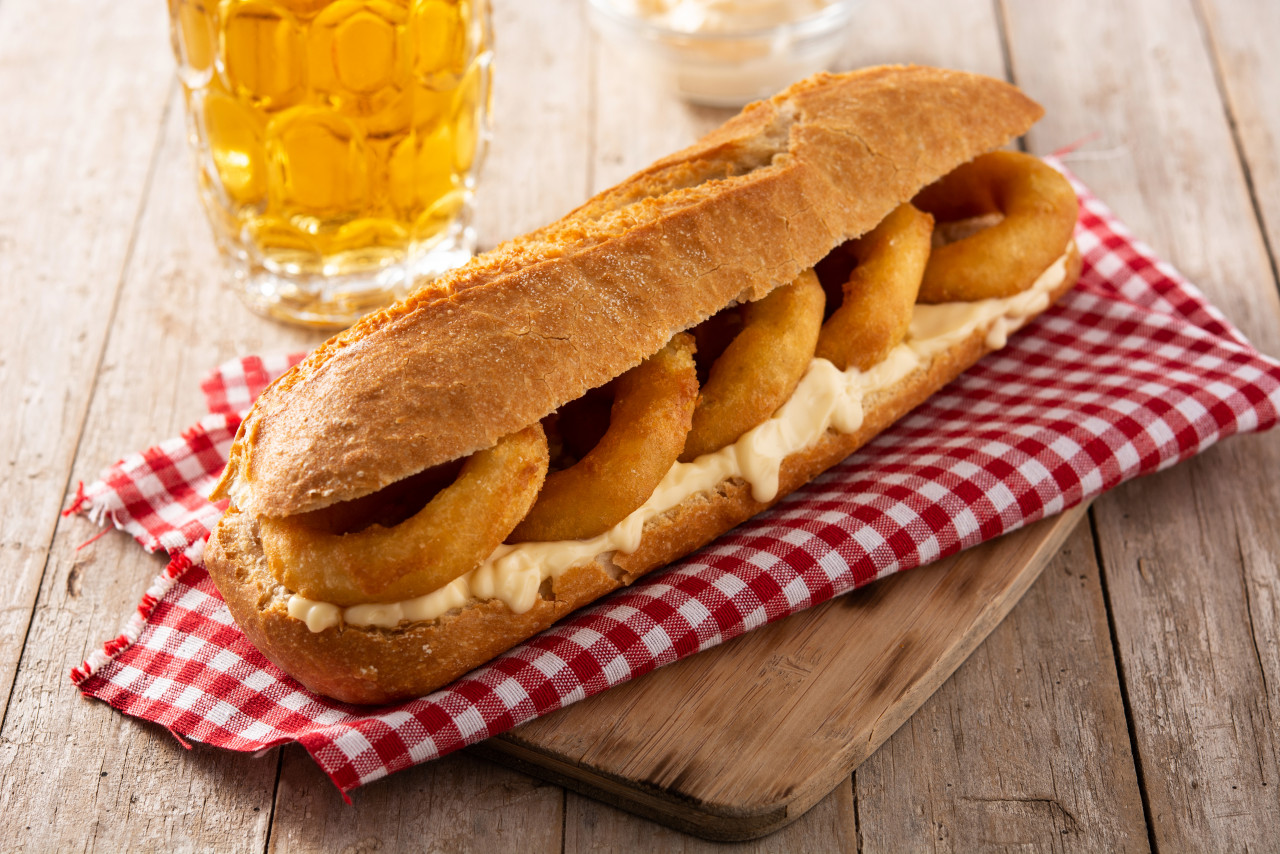 calamari rings sandwich with beer wooden table typica spanish food