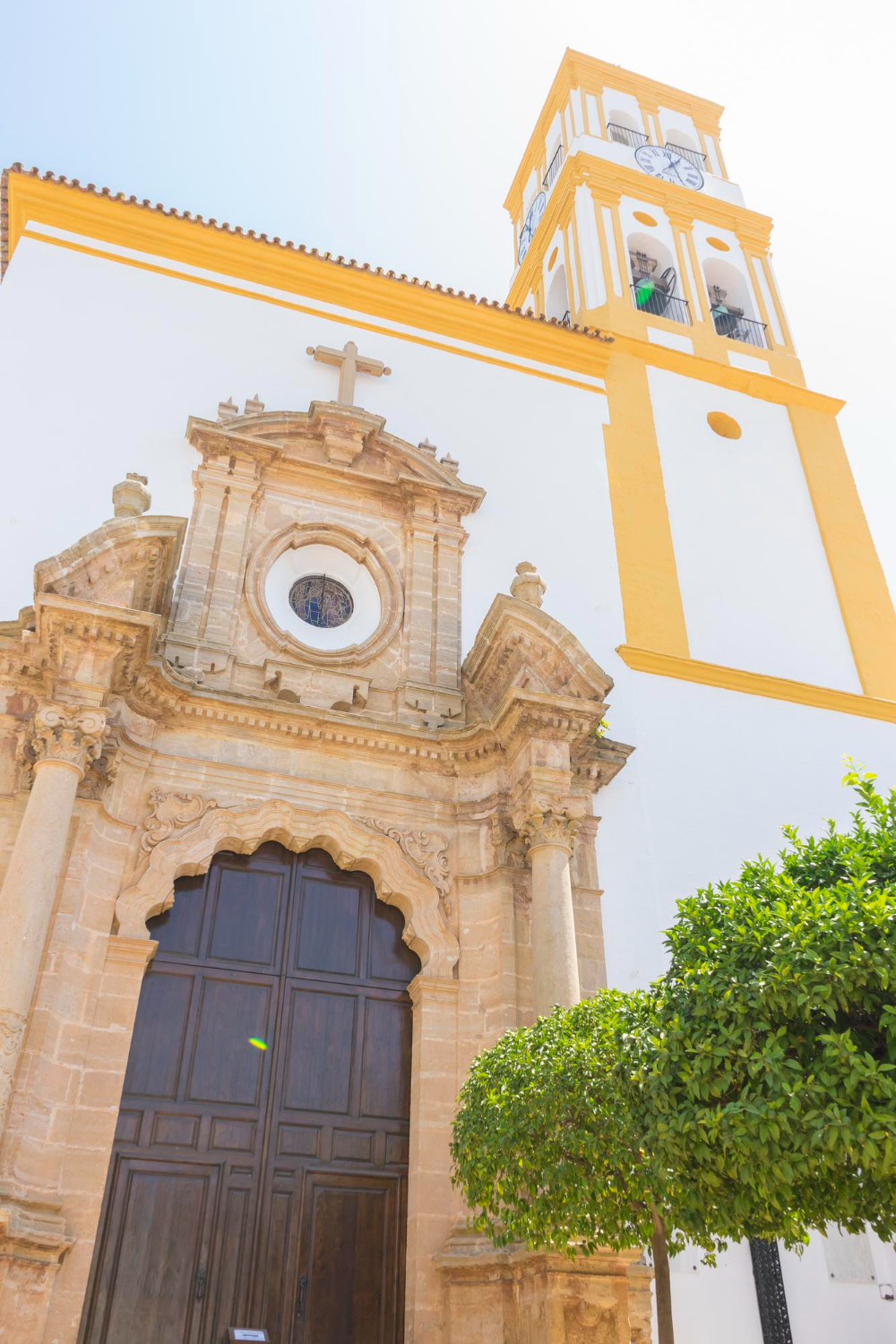 church facade with yellow trim marbella andalucia spain