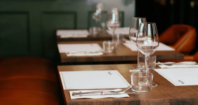 Clear Long Stemmed Wine Glass On Brown Table