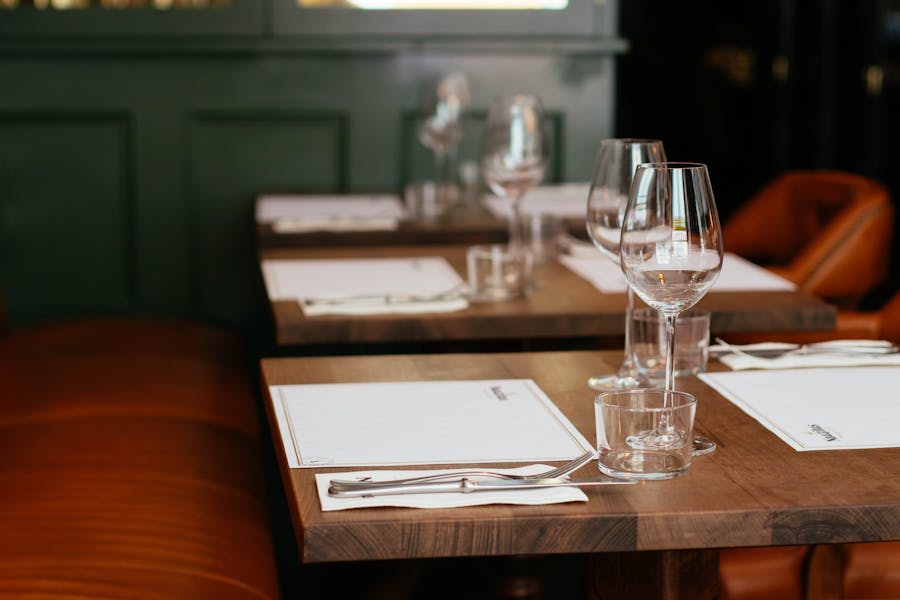 clear long stemmed wine glass on brown table