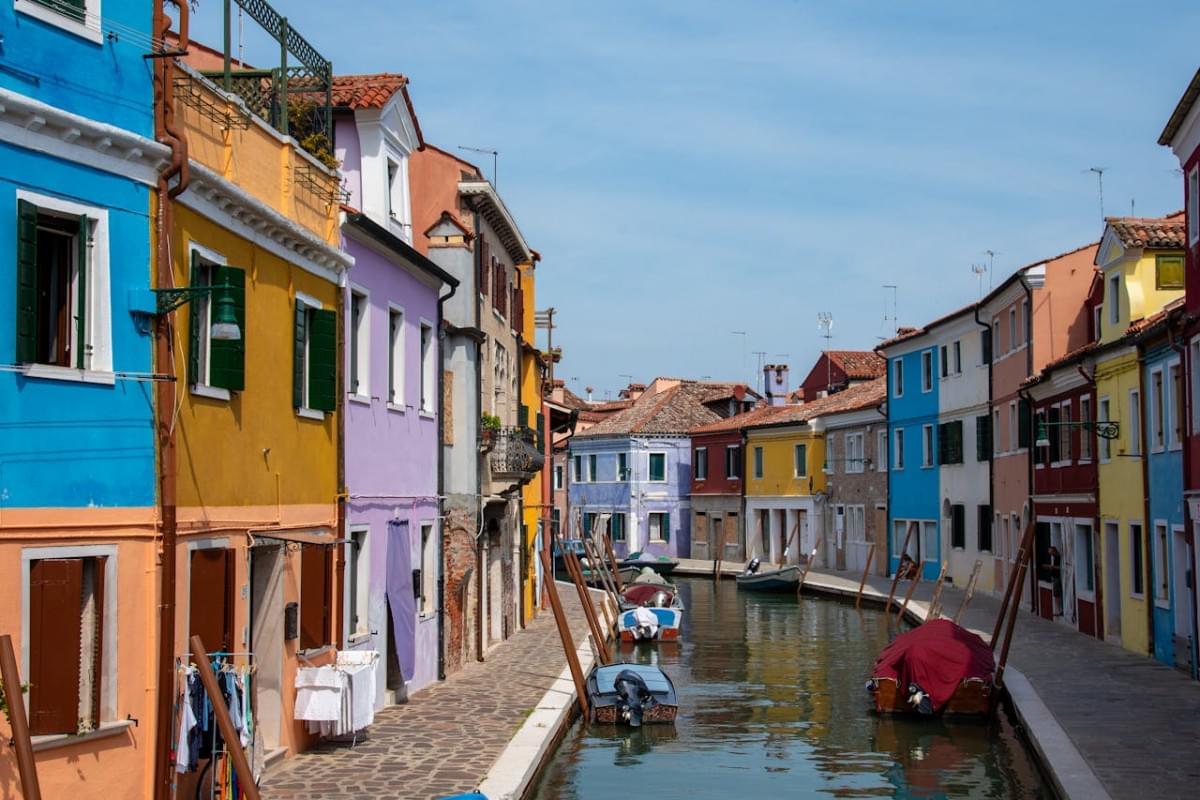 colorful houses on the sides of the canal in murano venice italy