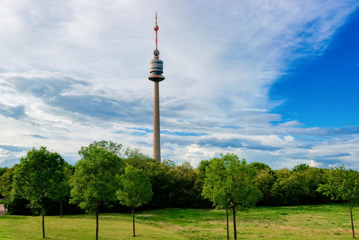 donauturm danube tv tower donaustadt district vienna austria television antenna park cityscape landscape with green trees grass wien europe