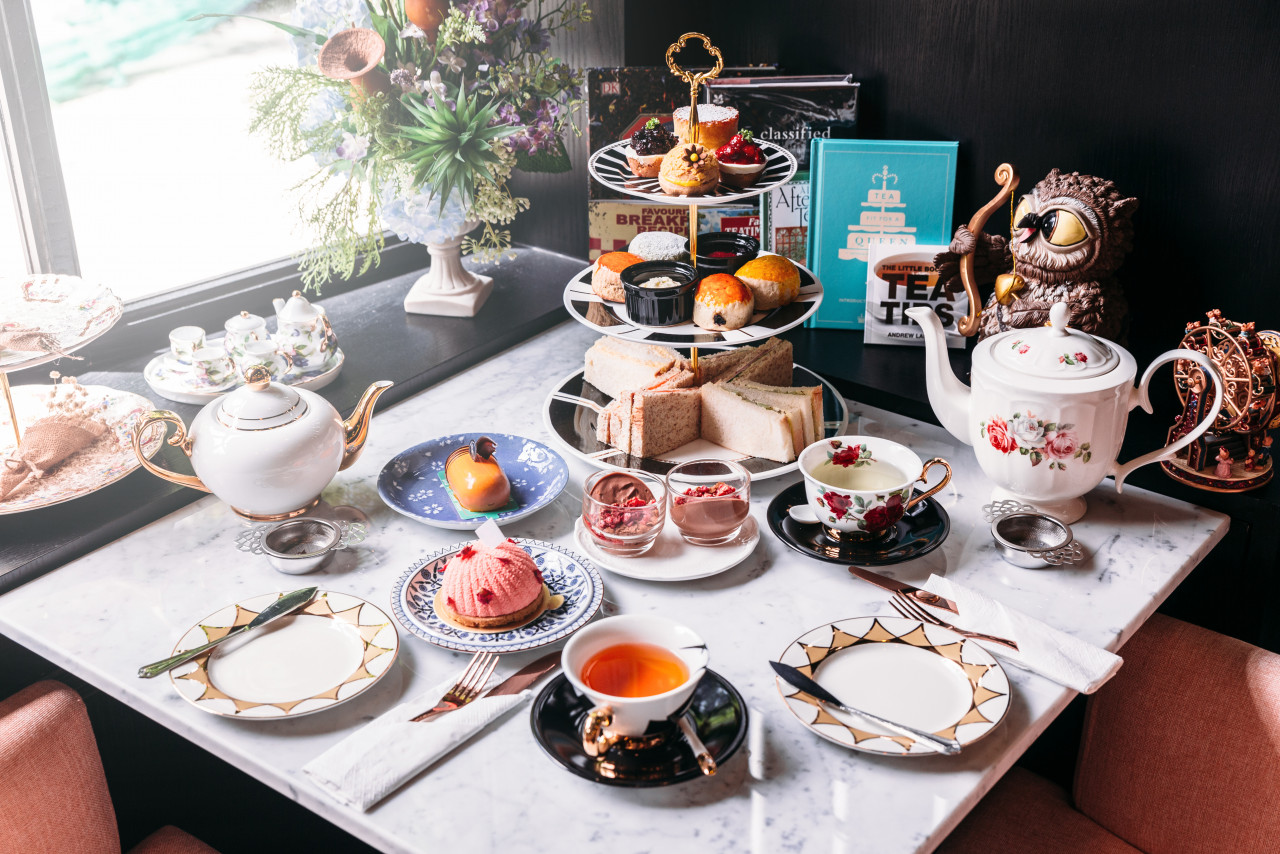 english afternoon tea set including hot tea pastry scones sandwiches mini pies