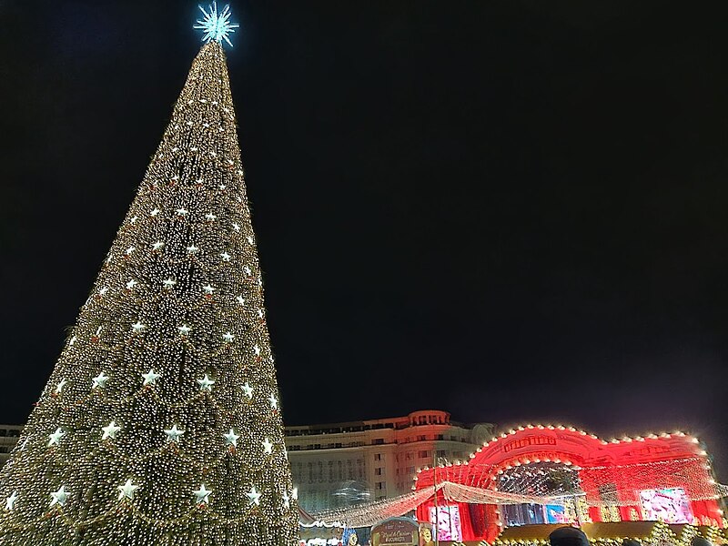 the palace of parliament and christmas tree at bucharest christmas market