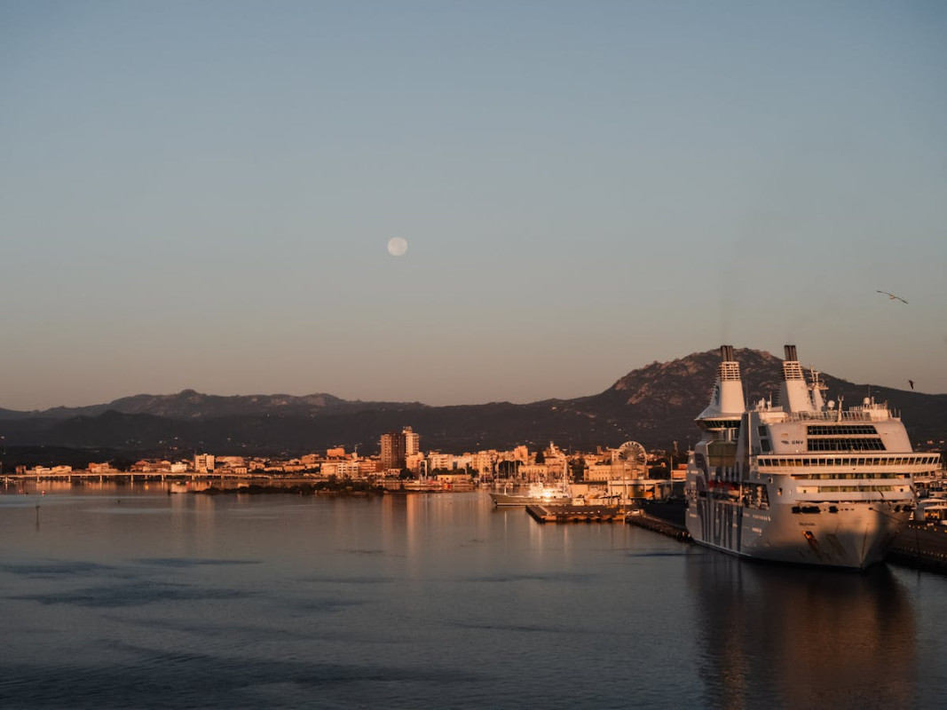 full moon in the evening sky over the harbor in olbia italy 3 1