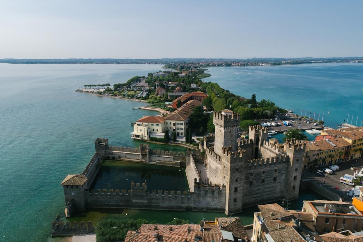 gray concrete castle near body of water