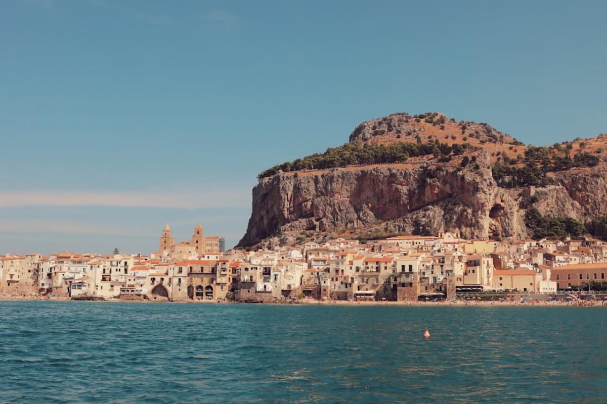 hill over sea coast in cefalu town in italy