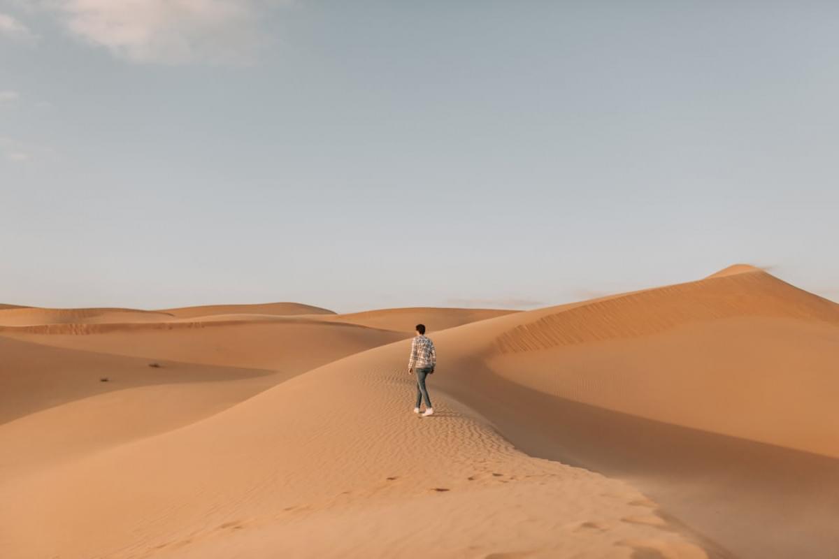 man walking on desert