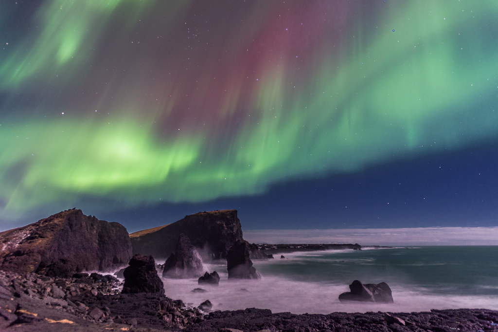 northern lights over reykjanes peninsula sea stacks iceland