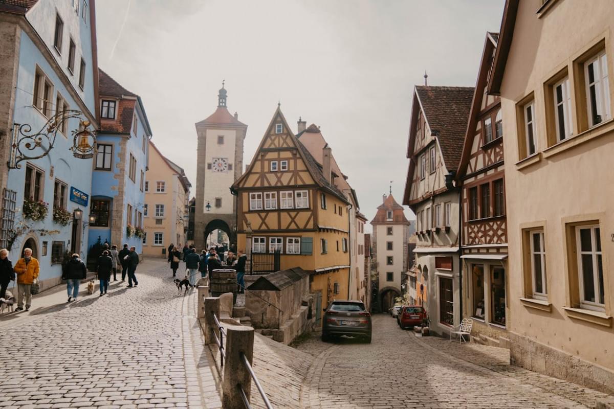 people in cobblestone alley 1