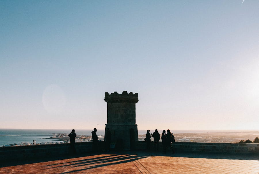 tourists admiring the views from the walls of montjuic castle in barcelona 1