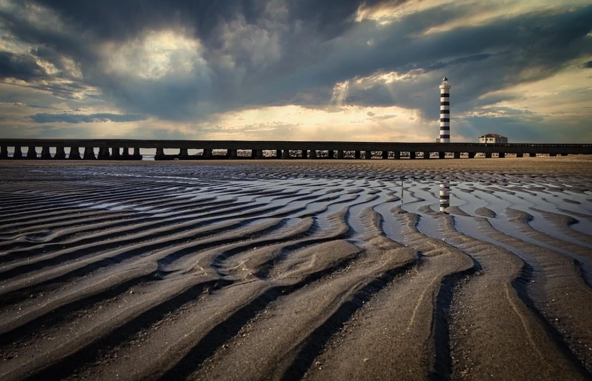 view of a beach pier and lighthouse in lido di jesolo italy 1