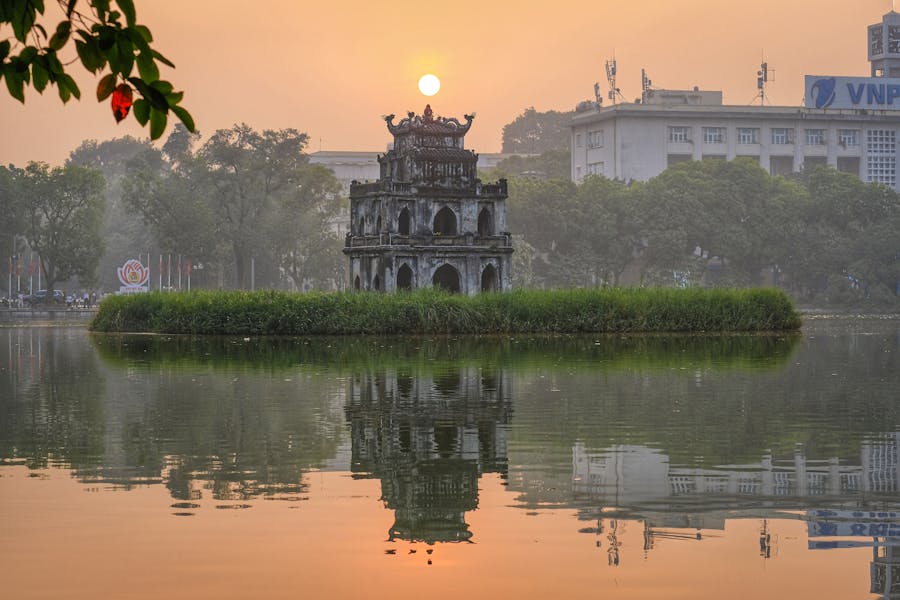 view of the tortoise tower in hanoi vietnam at sunset